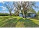 Large backyard with mature trees and lush grass at 10459 Myakka Blvd, Myakka City, FL 34251