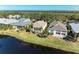 Aerial view of waterfront homes with lush landscaping and a canal at 11120 Sanctuary Dr, Bradenton, FL 34209