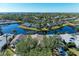 Aerial view of a waterfront community with houses and a large pond at 11120 Sanctuary Dr, Bradenton, FL 34209