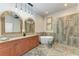 Elegant bathroom with double vanity, soaking tub, and walk-in shower at 11120 Sanctuary Dr, Bradenton, FL 34209