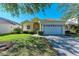 Single-story house with attached garage, featuring a manicured lawn at 11120 Sanctuary Dr, Bradenton, FL 34209
