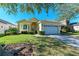 Single story house with a two car garage and lush landscaping at 11120 Sanctuary Dr, Bradenton, FL 34209