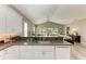 Kitchen features a large island with granite countertops and a view to the backyard at 11120 Sanctuary Dr, Bradenton, FL 34209