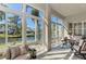 Bright sunroom with water views and comfy seating at 11120 Sanctuary Dr, Bradenton, FL 34209