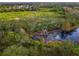 An aerial view of a waterfront property with lush conservation land at 11606 Water Poppy Ter, Lakewood Ranch, FL 34202