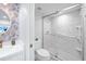 Clean bathroom with a walk-in shower and marble tile at 1333 Perico Pointe Cir, Bradenton, FL 34209