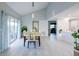 Spacious dining room with light beige chairs and a glass-top table, next to the kitchen at 1333 Perico Pointe Cir, Bradenton, FL 34209