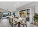 Bright dining room with a glass-top table and six chairs, overlooking the balcony at 1333 Perico Pointe Cir, Bradenton, FL 34209