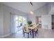Elegant dining room with a glass-top table and six light-beige chairs, adjacent to the kitchen at 1333 Perico Pointe Cir, Bradenton, FL 34209