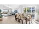 Modern dining area with a glass-top table and six chairs, open to the living room at 1333 Perico Pointe Cir, Bradenton, FL 34209