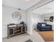 Entryway with console table and mirror; open to den with comfy chair at 1333 Perico Pointe Cir, Bradenton, FL 34209