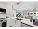 Modern kitchen with white cabinets, quartz countertops, and stainless steel appliances at 1333 Perico Pointe Cir, Bradenton, FL 34209