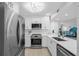 Modern kitchen with stainless steel appliances and white shaker cabinets at 1333 Perico Pointe Cir, Bradenton, FL 34209