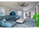 Bright living room features a sectional sofa, ottoman, and large window with water views at 1333 Perico Pointe Cir, Bradenton, FL 34209