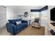 Cozy sitting area with blue couches, a large artwork, and a window seat at 1333 Perico Pointe Cir, Bradenton, FL 34209