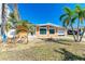 House exterior with palm trees and landscaping at 156 N Blvd Of The Presidents, Sarasota, FL 34236