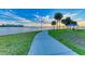 Curved waterfront walkway with scenic views and palm trees at 156 N Blvd Of The Presidents, Sarasota, FL 34236