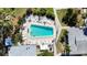 Aerial view of community pool, with surrounding loungers and walkways at 1582 Pleasant Rd # J35, Bradenton, FL 34207