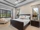 Spacious bedroom with a king-size bed, window seating and plantation shutters at 16333 Daysailor Trl, Lakewood Ranch, FL 34202