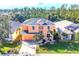Two-story house with a gray roof and peach exterior, situated on a landscaped lot at 1800 Scarlett Ave, North Port, FL 34289