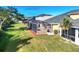 Screened lanai and spacious backyard with lush landscaping at 1800 Scarlett Ave, North Port, FL 34289