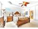 Spacious main bedroom with wood furniture and ceiling fan at 1800 Scarlett Ave, North Port, FL 34289