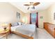 Comfortable bedroom with a ceiling fan, natural light, and neutral decor at 1800 Scarlett Ave, North Port, FL 34289