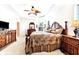 Spacious main bedroom with wood furniture and a ceiling fan at 1800 Scarlett Ave, North Port, FL 34289