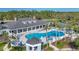 Community pool with adjacent clubhouse and tennis courts at 1800 Scarlett Ave, North Port, FL 34289