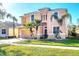 Two-story peach house with palm trees and a neatly landscaped lawn at 1800 Scarlett Ave, North Port, FL 34289