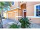 Inviting home exterior with a two-car garage, manicured landscaping, and a charming front entrance at 1800 Scarlett Ave, North Port, FL 34289