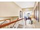 Upstairs hallway with hardwood floors and access to bedrooms at 1800 Scarlett Ave, North Port, FL 34289