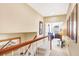 Hallway with wood railing and art leading to the next level at 1800 Scarlett Ave, North Port, FL 34289