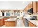 Well-equipped kitchen with wooden cabinets, modern appliances, and a center island at 1800 Scarlett Ave, North Port, FL 34289