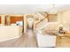 Living area with beige sofas and a view into the kitchen and stairs at 1800 Scarlett Ave, North Port, FL 34289