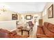 Spacious living room featuring hardwood floors, comfortable leather seating, and neutral wall color at 1800 Scarlett Ave, North Port, FL 34289