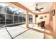 Enclosed patio area with a pool and seating at 1800 Scarlett Ave, North Port, FL 34289