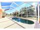 Inviting screened pool and spa with a spacious deck at 1800 Scarlett Ave, North Port, FL 34289