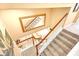 View from above of a staircase with mirror reflecting the living room at 1800 Scarlett Ave, North Port, FL 34289