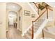 Inviting stairway with wooden banister and white spindles, leading to the upper level of the home at 1800 Scarlett Ave, North Port, FL 34289