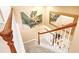 Carpeted stairway with a decorative painting, a mirror, and a view of the living room below at 1800 Scarlett Ave, North Port, FL 34289