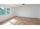 Spacious bedroom with light wood floors and a large window at 208 36Th W St, Bradenton, FL 34205