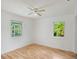 Well-lit bedroom with hardwood floors and two windows at 208 36Th W St, Bradenton, FL 34205