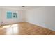 Spacious bedroom with hardwood floors and a large window at 208 36Th W St, Bradenton, FL 34205