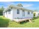 Side view of the house showcasing the wood deck and spacious yard at 208 36Th W St, Bradenton, FL 34205