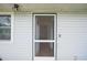 Front entrance with a screen door leading into a hallway with light wood floors at 208 36Th W St, Bradenton, FL 34205
