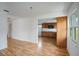 Open living space with wood floors and view into kitchen area at 208 36Th W St, Bradenton, FL 34205
