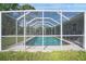 Sparkling blue pool seen through a screened enclosure at 208 36Th W St, Bradenton, FL 34205