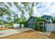 Two-car garage with a side yard and a white fence at 2690 Temple St, Sarasota, FL 34239