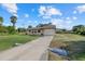 Tan house with landscaping and a driveway at 292 Dorchester St, Port Charlotte, FL 33954